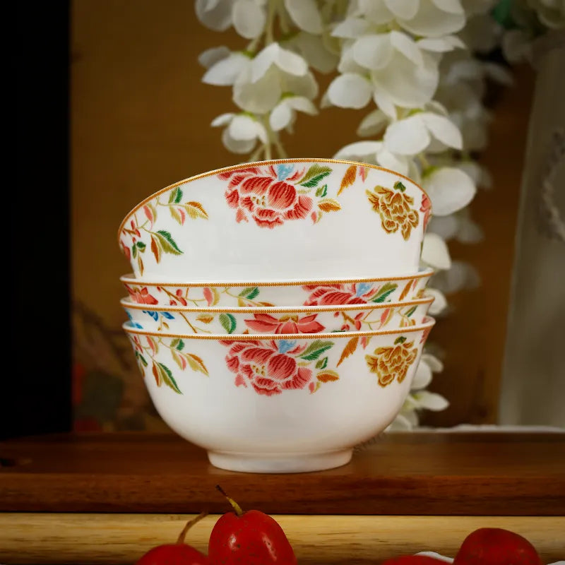 Front view of stacked floral bone china bowls on display shelf.