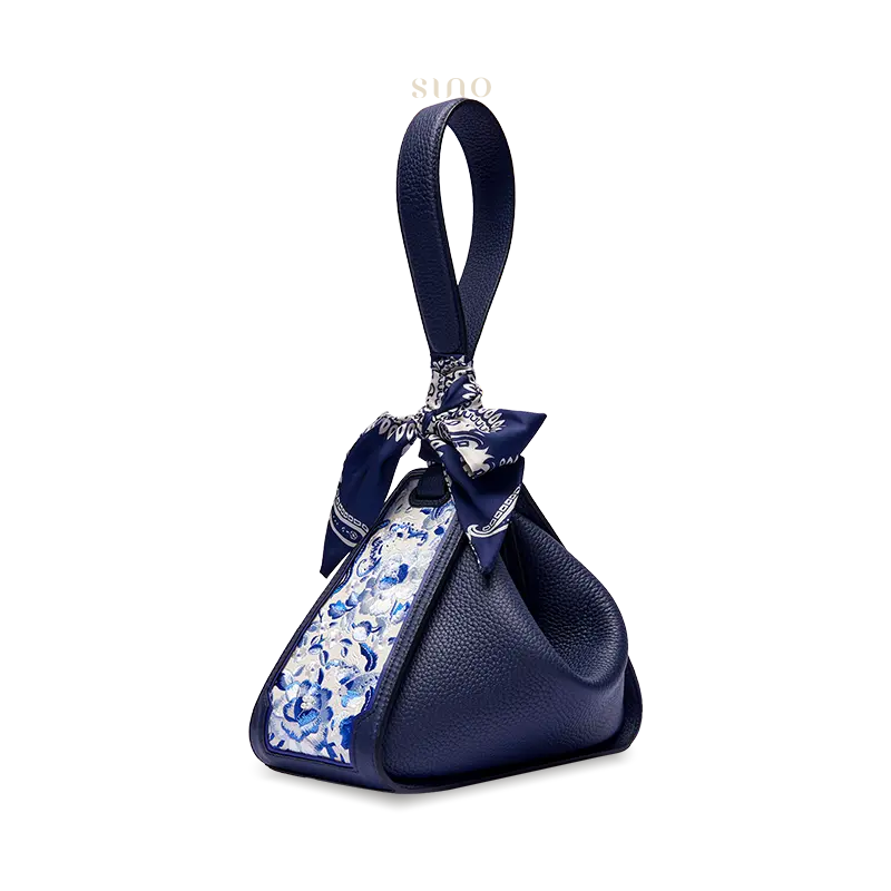 Side view of the blue leather Zongzi handbag with SANLAN blue floral embroidery and decorative silk scarf.