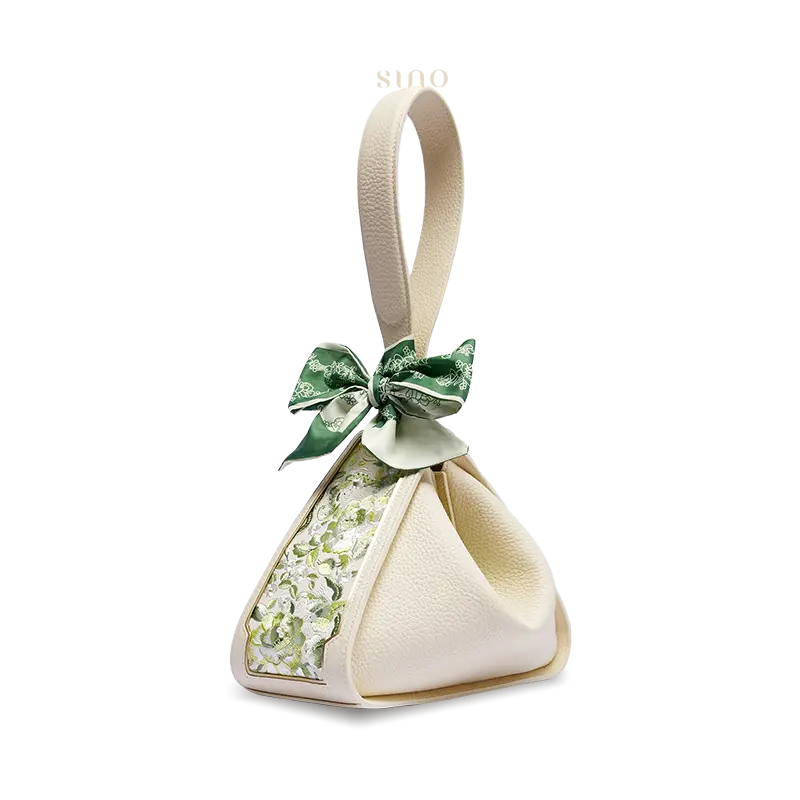 Side view of a beige Zongzi handbag with green SANLAN floral embroidery and a decorative silk scarf.