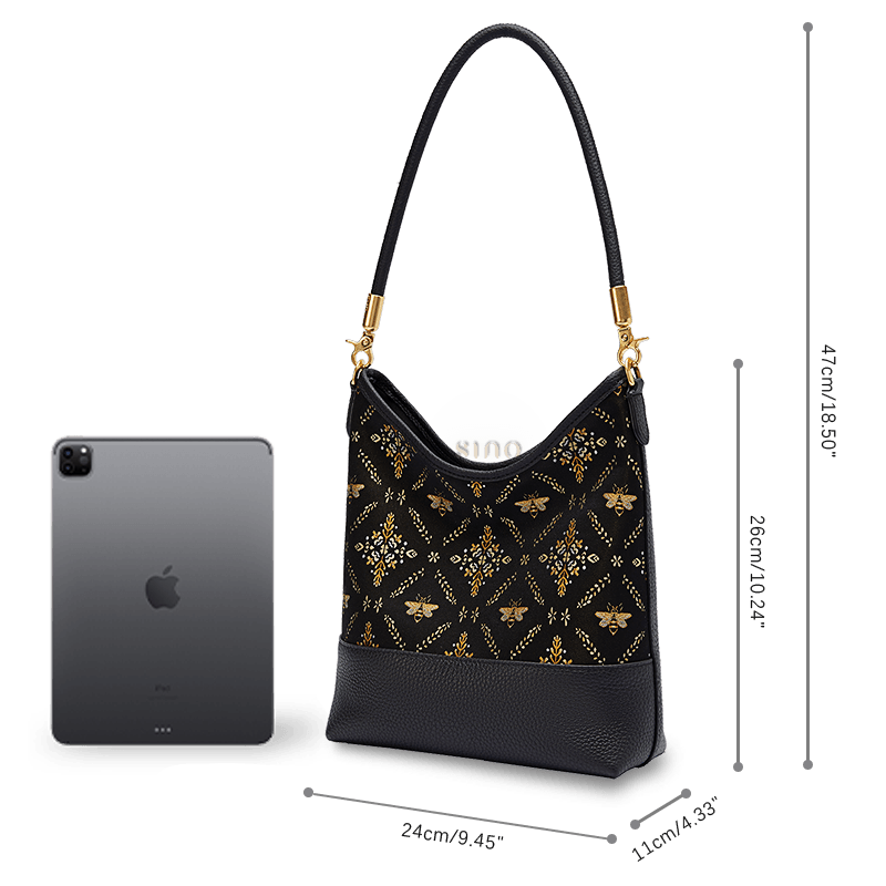 Size and capacity comparison of the Gilded Jade leather shoulder bag beside a tablet.