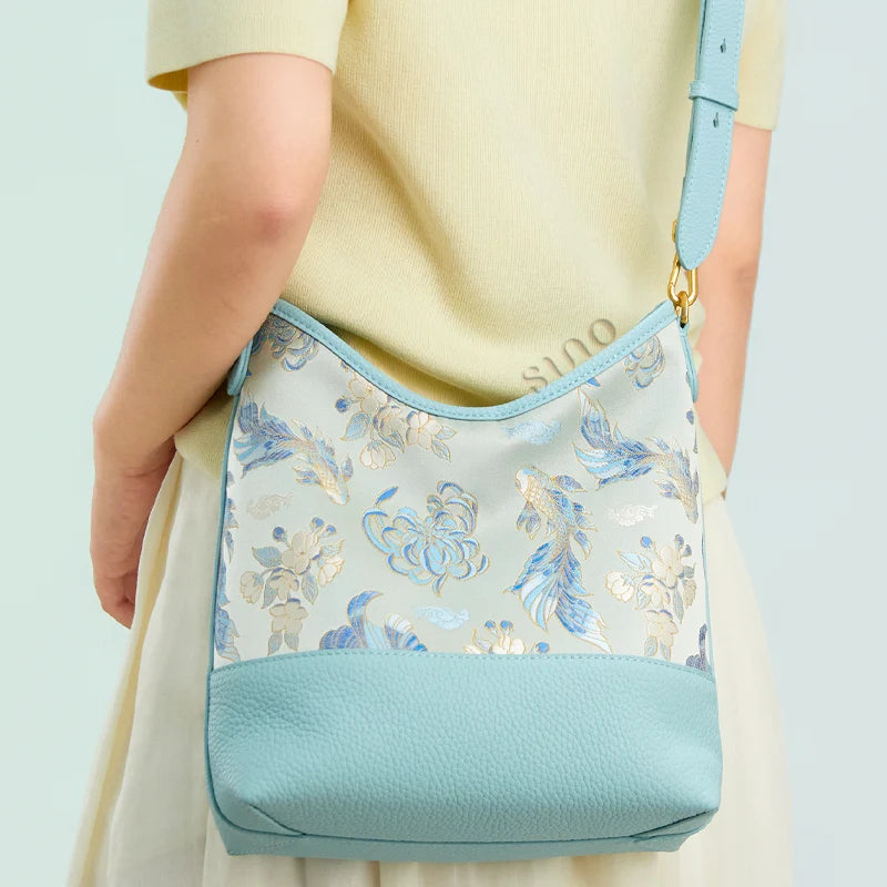 Back view of a model wearing the light blue Golden Jade Romance Shu Brocade shoulder bag.