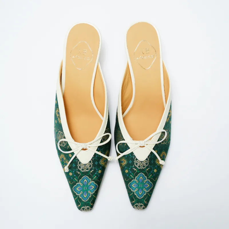 Top view of luxury Shu Brocade mule shoes featuring Ruyi motif and delicate bow detail.