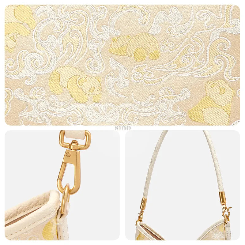 Close-up detail of the Shu brocade Panda and Dragon pattern, gold-tone hardware, and shoulder strap on the leather shoulder bag.
