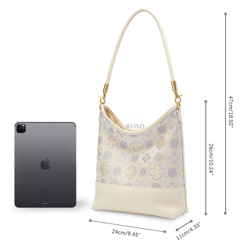 Size and capacity comparison of the Persimmon Calyx Shu Brocade leather shoulder bag beside a tablet.
