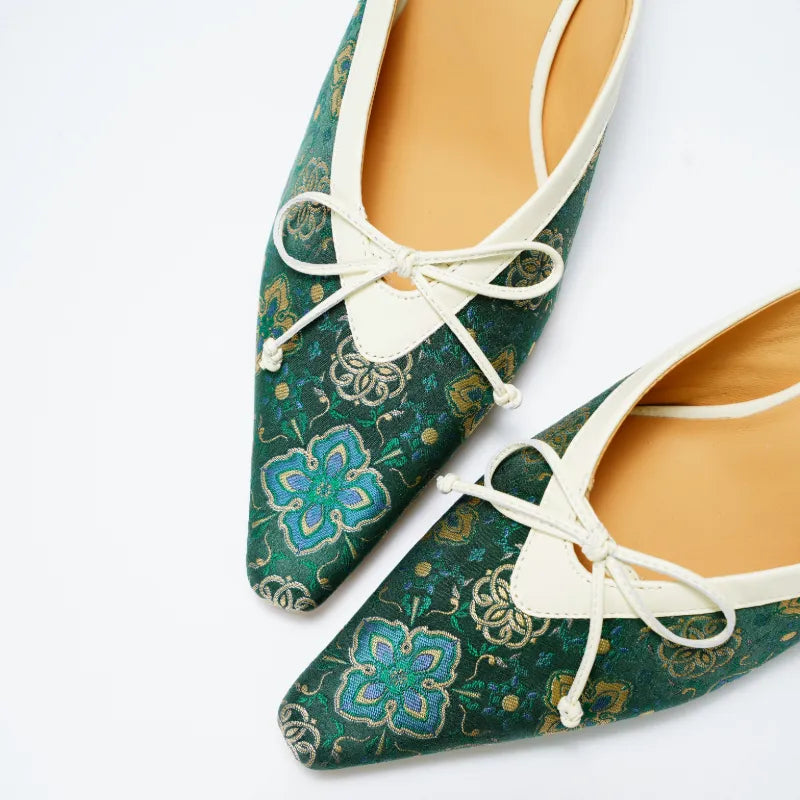 Close-up detail of Shu Brocade Ruyi motif on luxury women's mule shoes with traditional textile patterns.
