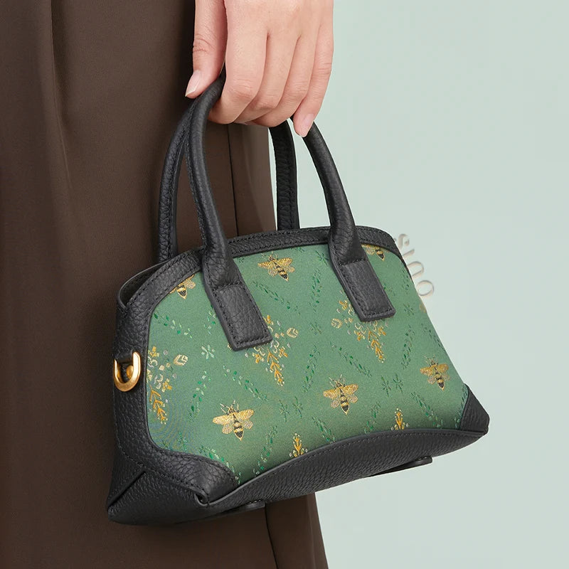 Model hand-carrying the Luxury Shu Brocade Verdant Layers Leather Top Handle Bag.