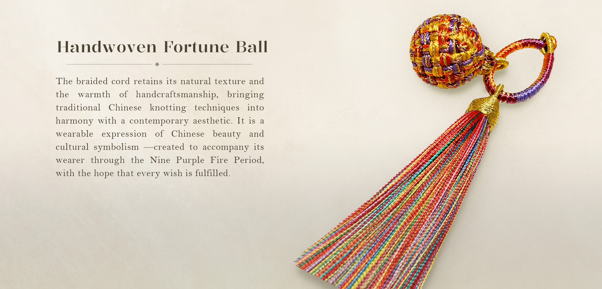 A handwoven Nine Purple Li Fire Fortune Ball Charm with a colorful braided tassel on a soft cream background.