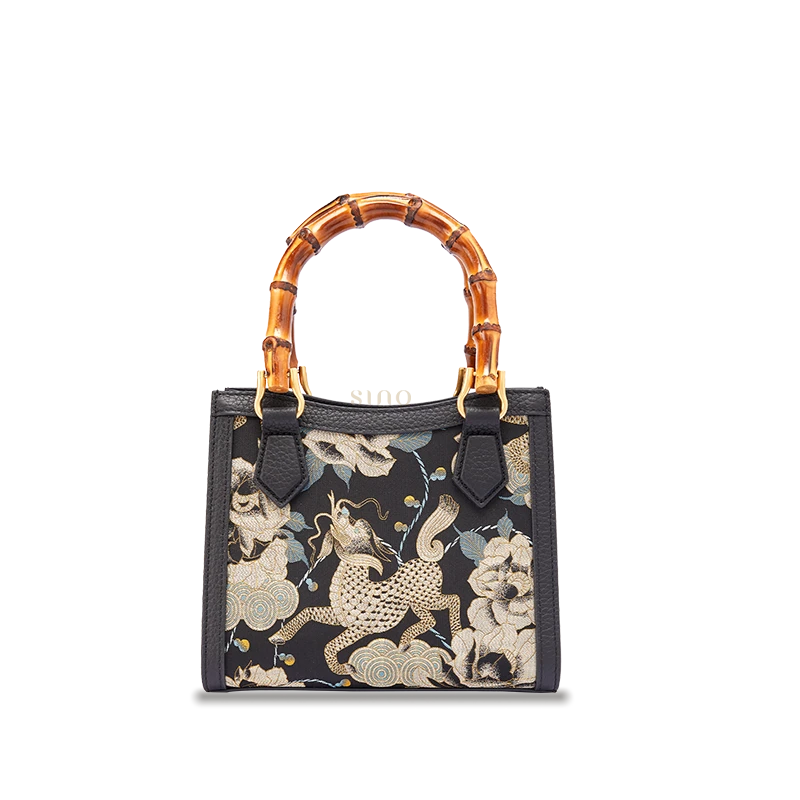 Song Brocade Black Gold Qilin Peony motif leather bamboo handle handbag featuring traditional Chinese textile craftsmanship.