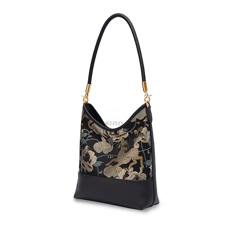 Angled view of a Chinoiserie Song Brocade shoulder bag featuring golden Qilin, peony, and cloud motifs.
