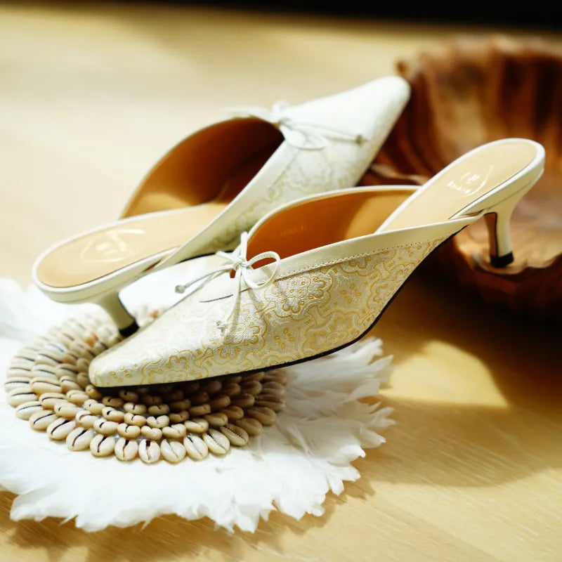 Close-up view of Song Brocade Ding Sheng kitten heel mules highlighting the intricate woven texture and Chinese pattern.