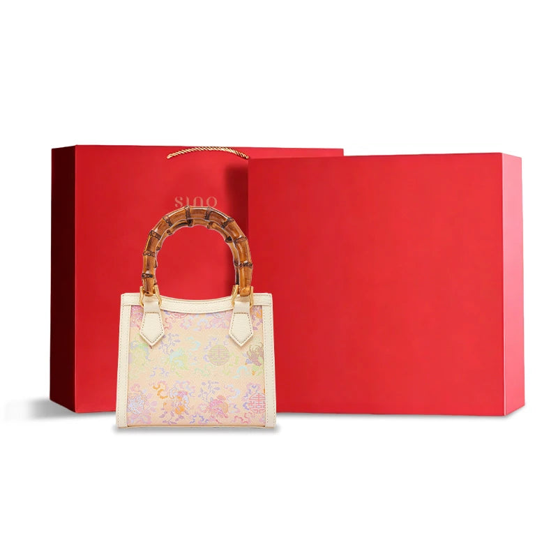 Song Brocade Fortune & Longevity leather bamboo handle handbag displayed with elegant gift packaging for a luxury Chinese heritage gift.