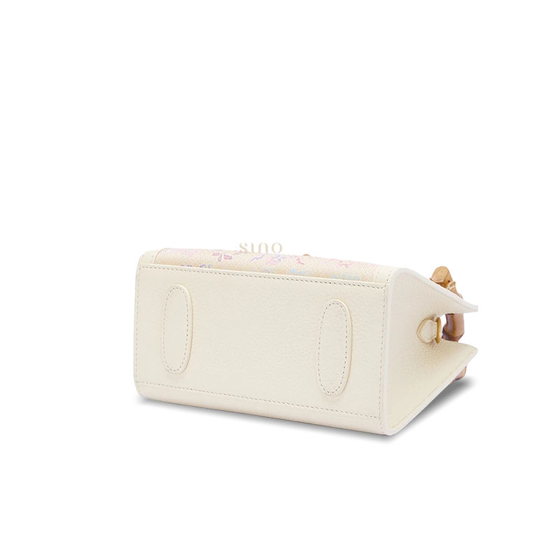 Bottom detail of Song Brocade bamboo handle handbag displaying durable leather base and meticulous craftsmanship.