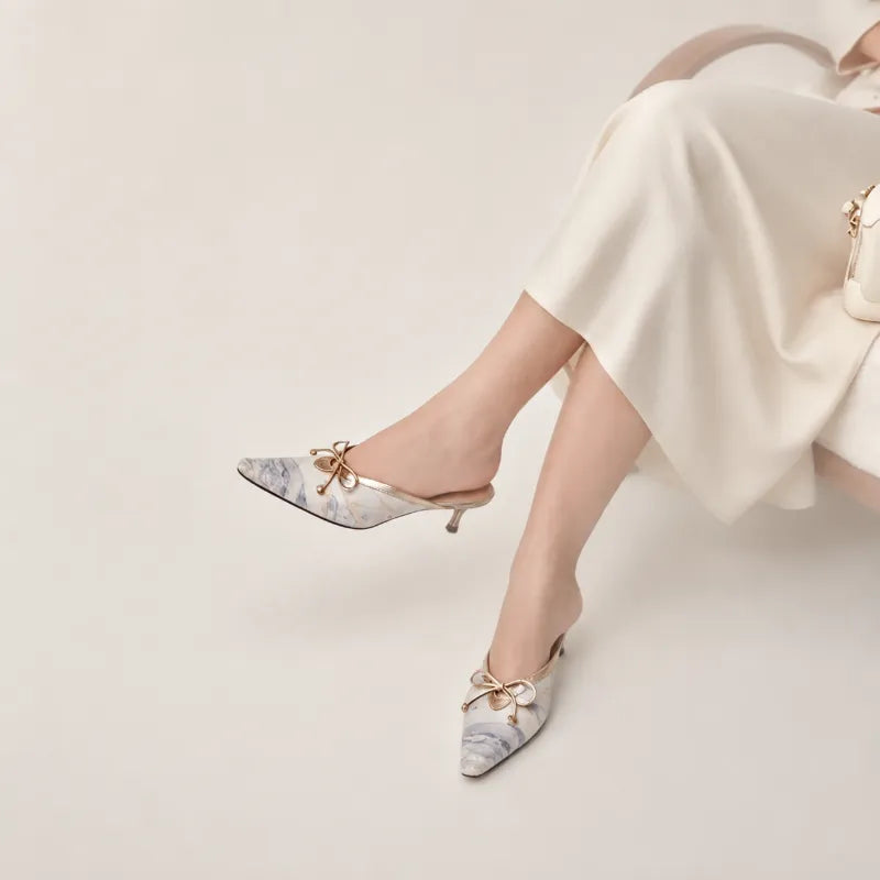 Woman wearing Song Brocade Moonlit Splendor kitten heel mules with an elegant modern outfit.