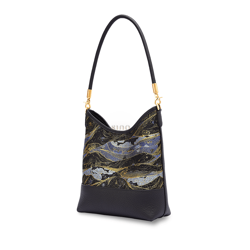 Angled view of a Chinoiserie Moonlit Splendor shoulder bag crafted from Song Brocade and black leather.