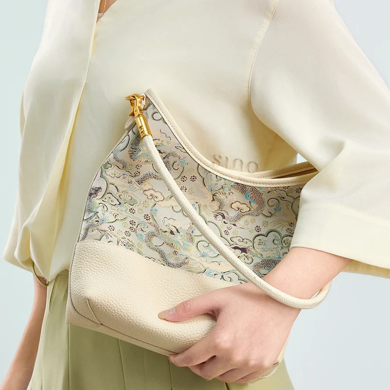 Model carrying the Chinoiserie Luxury Song Brocade Ox-Head Dragon Leather Shoulder Bag in a close-up lifestyle styling view.