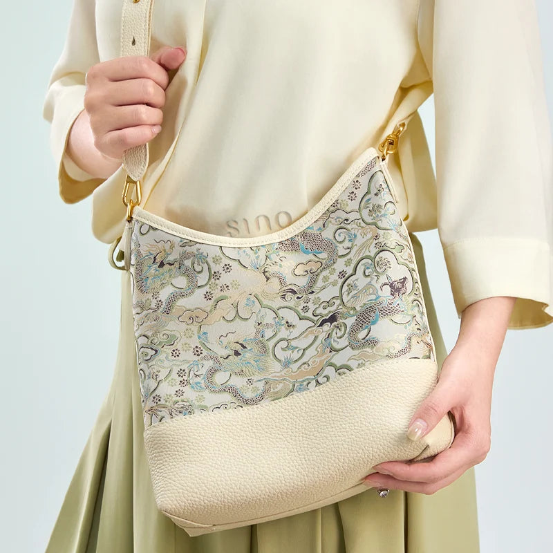 Front lifestyle view of the model wearing the Chinoiserie Luxury Song Brocade Ox-Head Dragon Leather Shoulder Bag with adjustable strap.