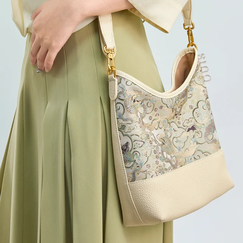 Side lifestyle view of the Chinoiserie Luxury Song Brocade Ox-Head Dragon Leather Shoulder Bag showing the elegant silhouette and brocade pattern.