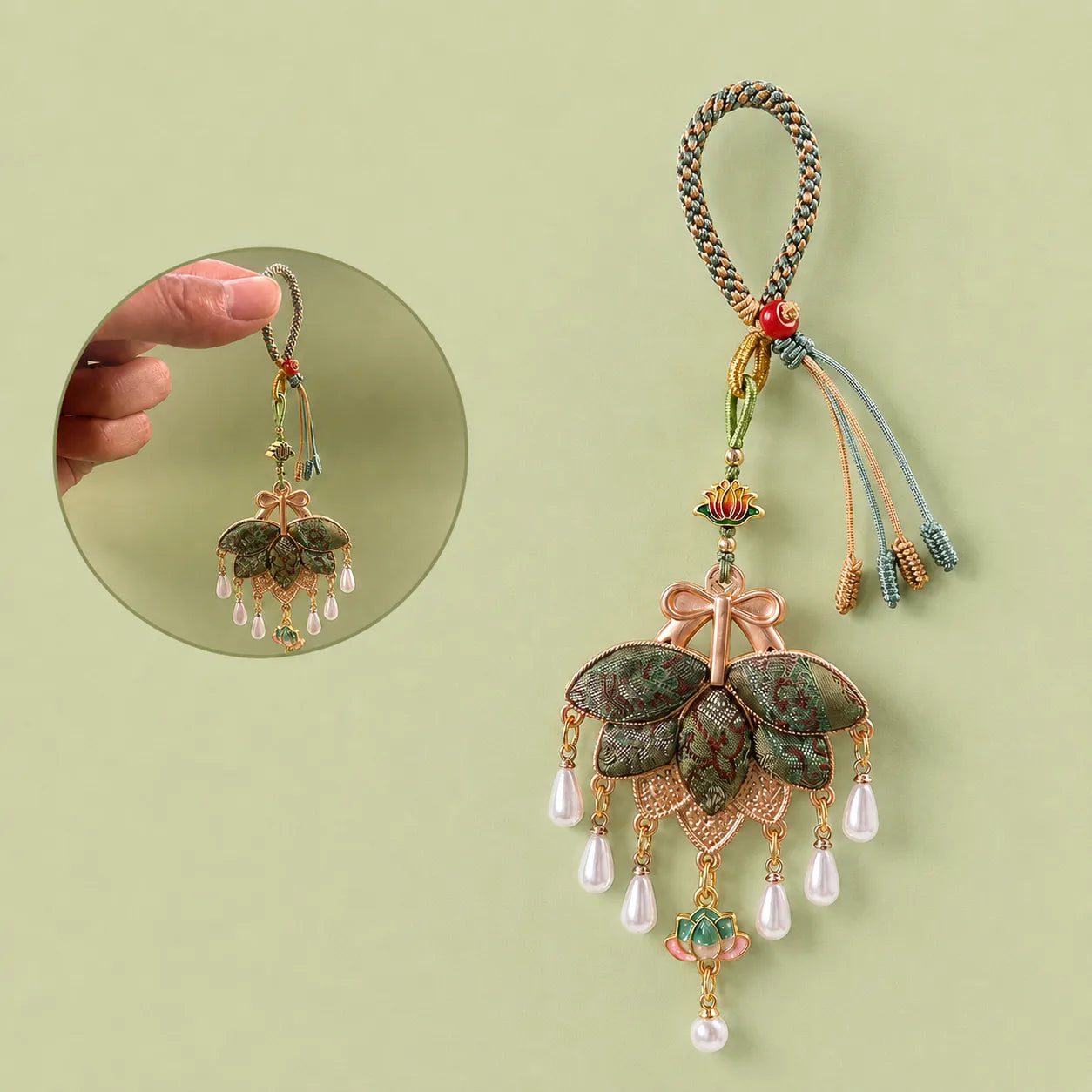 Green Song Brocade pomelo leaf tassel bag charm detail view showing the braided hanging loop, layered woven leaves, lotus ornament, and pearl-like pendants.