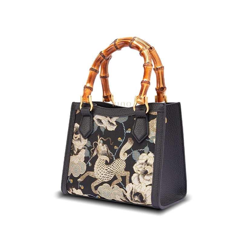 Front view of Song Brocade Qilin Peony leather bamboo handle handbag with gold embroidered silk brocade panel.