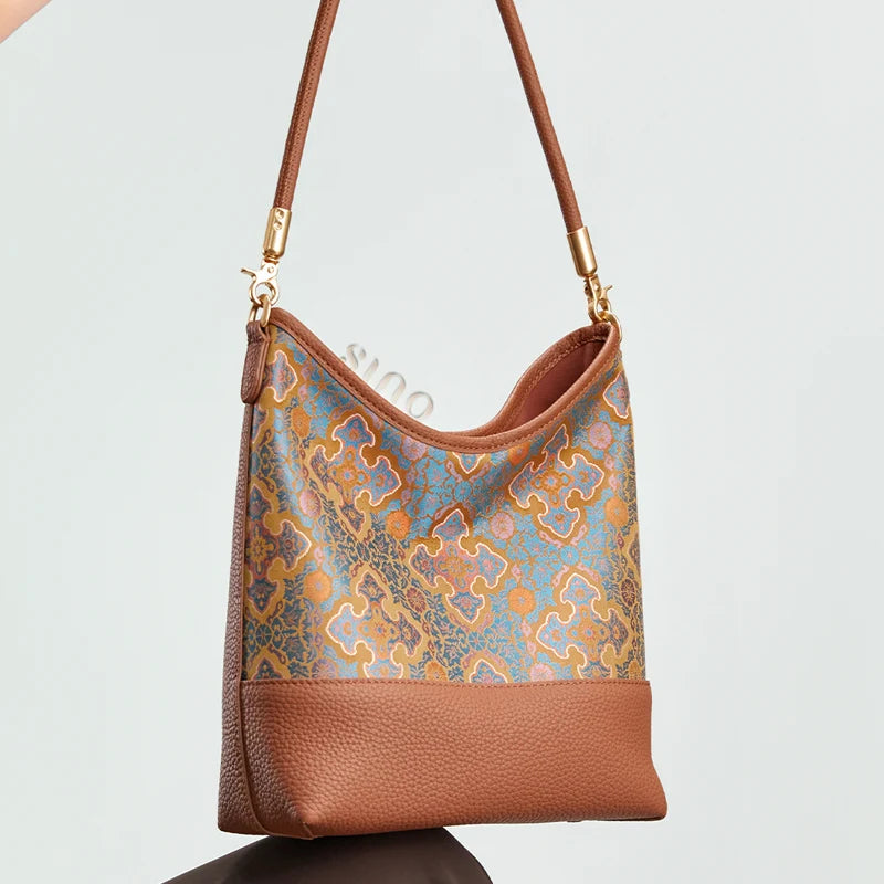 Lifestyle view of the Chinoiserie Song Brocade Ruyi Motif Leather Shoulder Bag highlighting its curved silhouette and woven pattern.