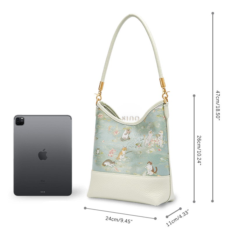 Size and capacity comparison of the Springtime Tales Song Brocade leather shoulder bag beside a tablet.