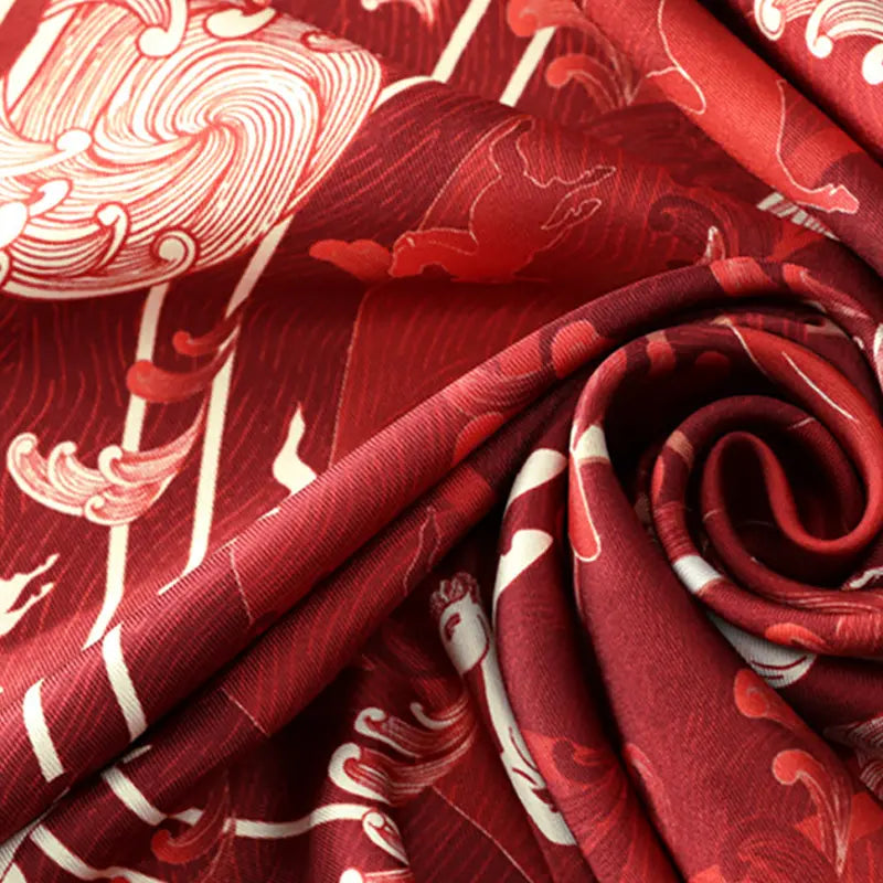 Close-up of premium mulberry silk fabric on the Steed Across the Tides Square Scarf showing its smooth texture, sheen and horse-wave print.