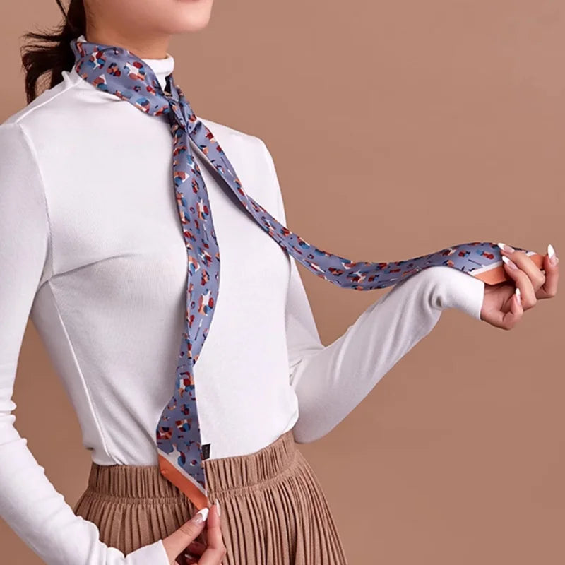 Woman wearing the blue Suzhou Museum Artifact Print Mulberry Silk Twilly as a long skinny neck scarf.