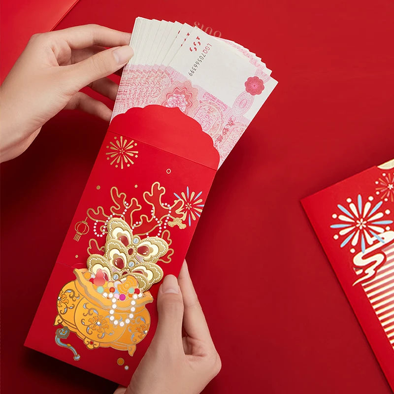 Hands placing banknotes into a red Chinese New Year money envelope featuring ornate gold artwork and colorful traditional Chinese motifs.