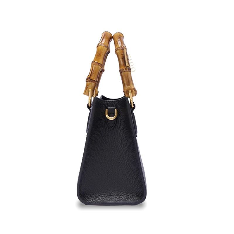 Side view of Zhangrong Silk Velvet bamboo handle handbag showing elegant structured shape and premium cowhide leather craftsmanship.