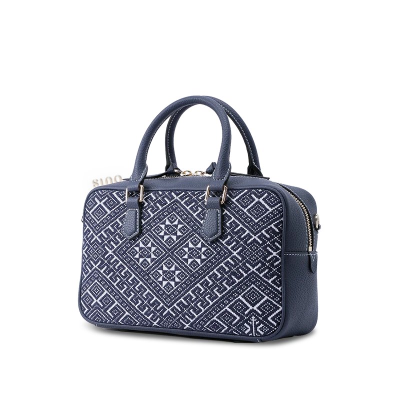 Side profile of Zhuang Brocade crossbody bag, highlighting its structured silhouette (25.5cm length × 9cm depth) and embroidered side panels.