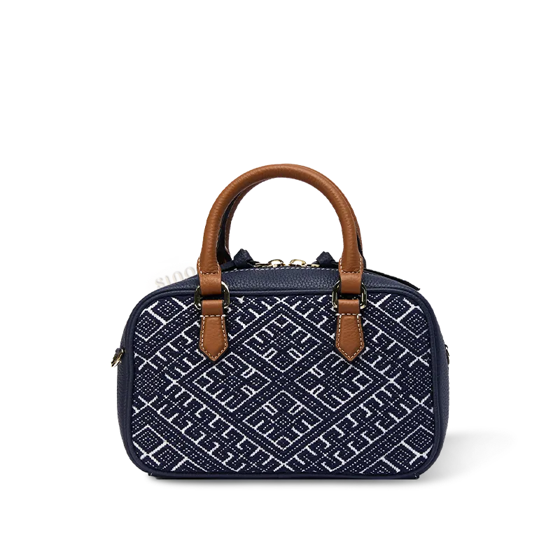 Indigo flying swallow Zhuang brocade Boston bag with leather handles.