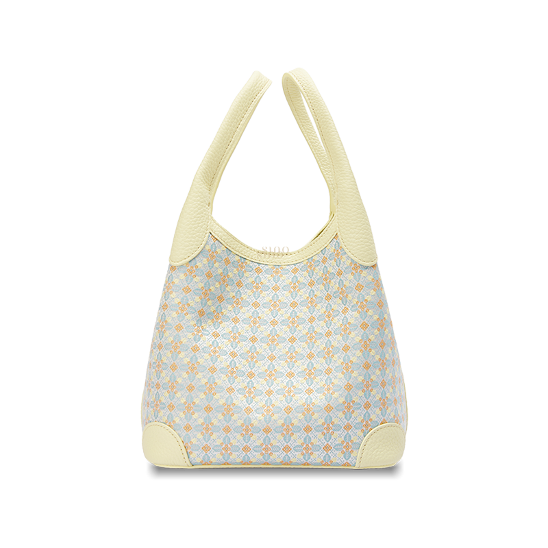 Front view of the Luxury Zhuang Brocade Osmanthus Motif Leather Basket Tote Bag, featuring a pale yellow leather trim and a woven geometric osmanthus-inspired brocade pattern.