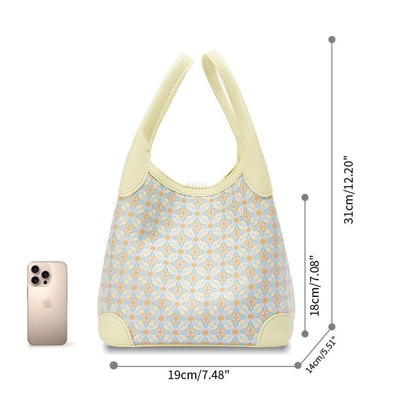Size reference image of the Luxury Zhuang Brocade Osmanthus Motif Leather Basket Tote Bag, shown with a phone for scale and everyday carrying capacity.