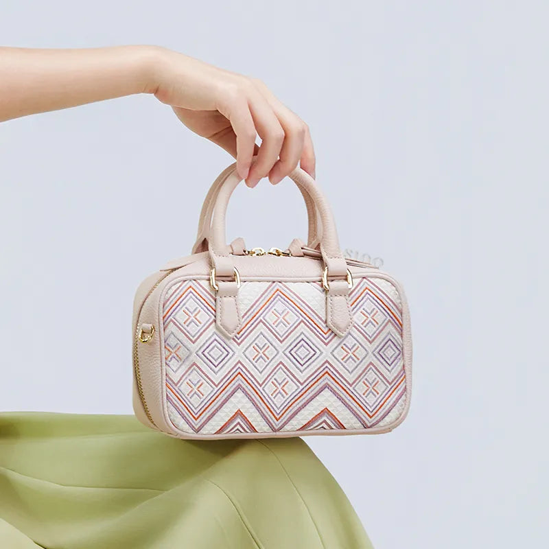 Seated model showcasing brocade embroidery on lap.